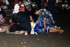This dancer has just thrown himself to the dragon. There are always helpers in the corral, dressed in street clothes and smoking, who help the dancers when they drop something or need help with props or their trance.