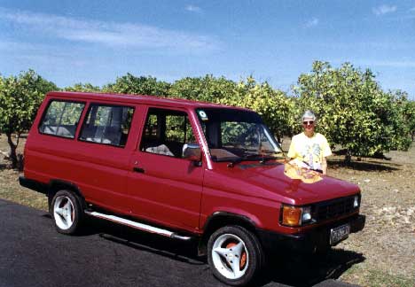 The elderly Kijang (Indonesian version of a Toyota) we rented. The picture does not do justice to the color. The car without driver or gas would be Rp170,000 for a day. With driver and gas it was 250,000. The exchange rate is about 9200 to the US$. - jpg - 26388 Bytes